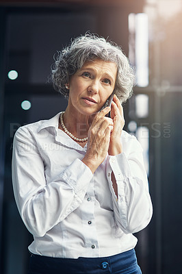 Buy stock photo Cropped shot of a mature businesswoman looking worried while talking on a cellphone