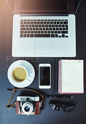 Buy stock photo Startup business, photographer and desk with laptop from above, freelance and research in home office. Smartphone, coffee and notebook on table in study for marketing, scheduling or editing in house