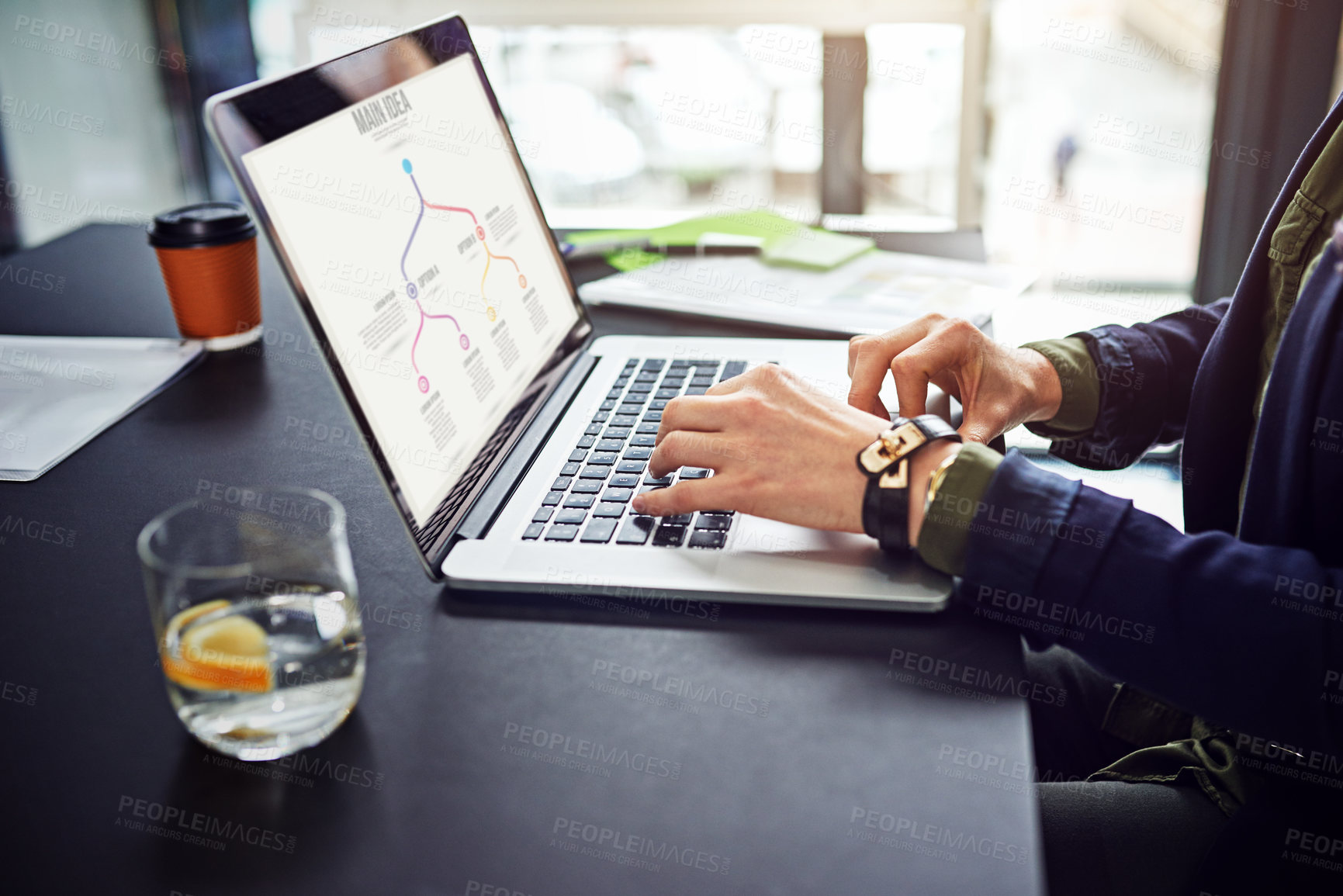 Buy stock photo Cropped shot of an unidentifiable businesswoman using her laptop at her desk