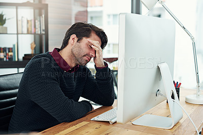 Buy stock photo Cropped shot of a young businessman looking dismayed by something on his computer