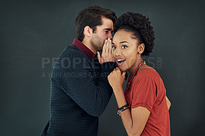 Buy stock photo Cropped shot of two people gossiping against a dark background