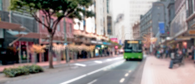 Buy stock photo Blur and defocused city bus parked on a road or street abroad and overseas. Travel and tourism on public transport during morning commute downtown. Blurry vision, eye disorder and vertigo problems