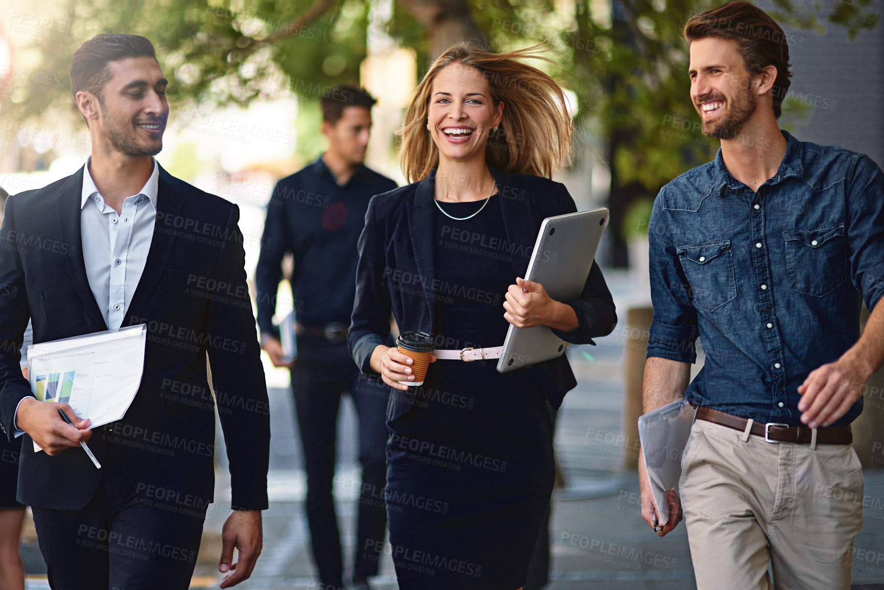 Buy stock photo Shot of corporate colleagues walking down the street
