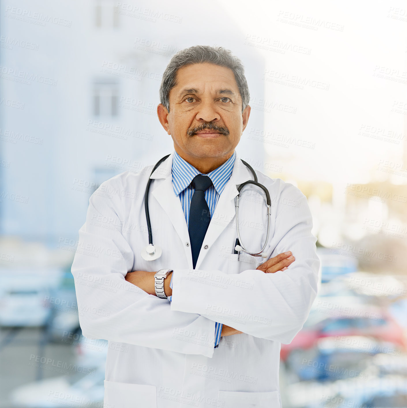 Buy stock photo Portrait of a confident and mature doctor folding his arms