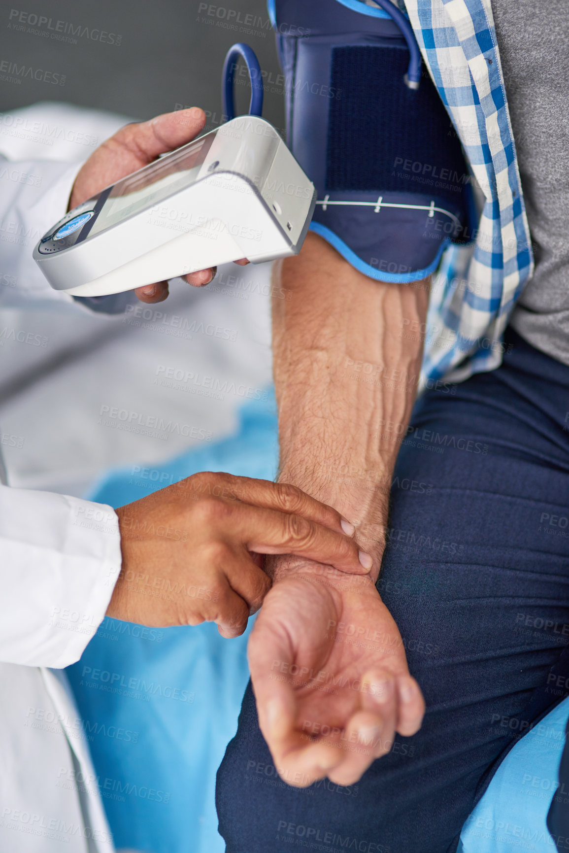 Buy stock photo Cropped shot of a doctor taking a patient’s blood pressure reading
