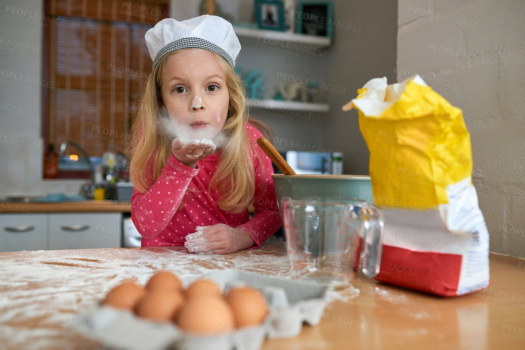 Buy stock photo Happy, child or young chef portrait baking in kitchen for learning, practice or making dessert. Fun, chaos and girl mixing flour or ingredients in bowl with energy and excitement for home made treat