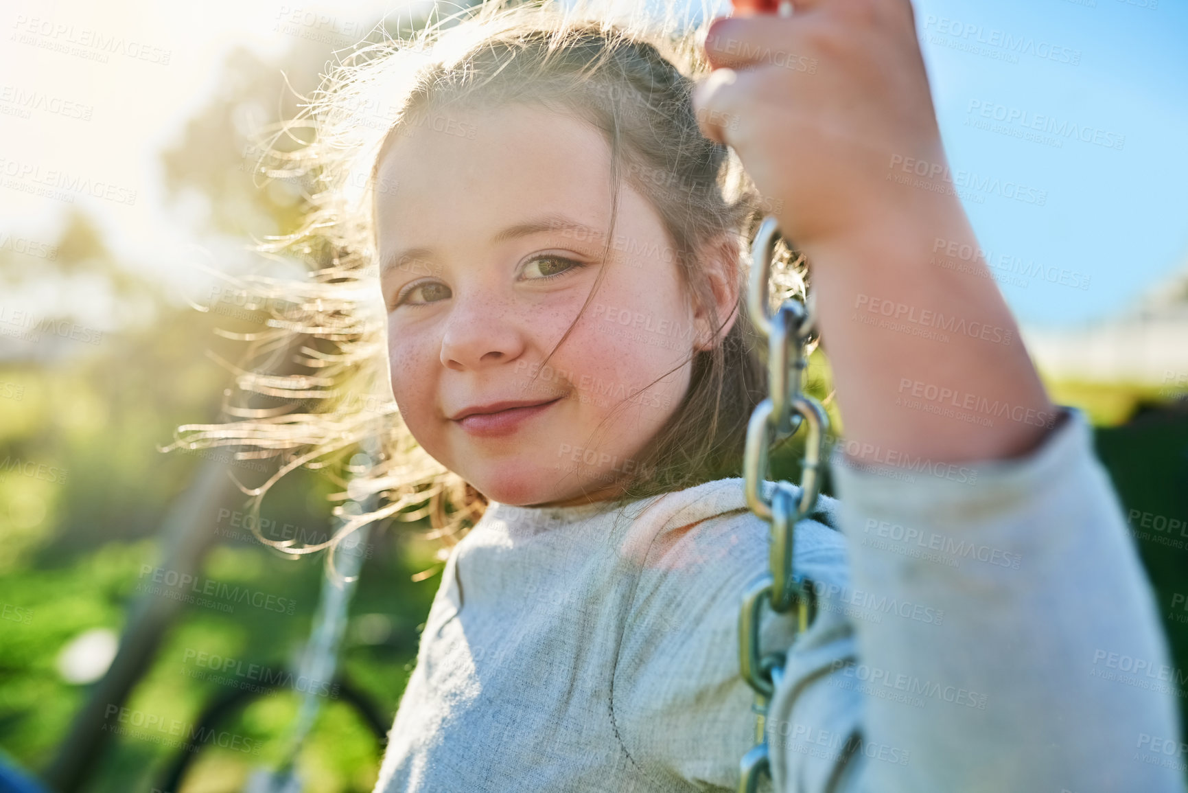 Buy stock photo Child, relax and portrait on swing in playground on vacation or holiday in summer with freedom. Happy, girl and play outdoor in backyard, park or kid fly in air with energy in garden sunshine