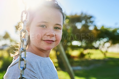 Buy stock photo Child, relax and portrait on swing in playground on vacation or holiday in summer with freedom. Young, girl and play outdoor in backyard, park or kid in garden on break with energy in sunshine