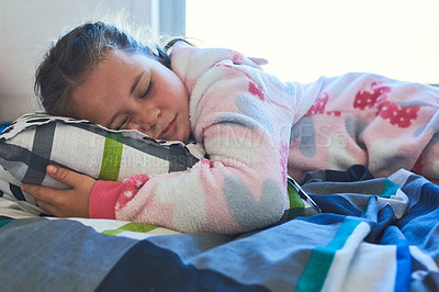Buy stock photo Cropped shot of a cute little girl sleeping on a bed at home