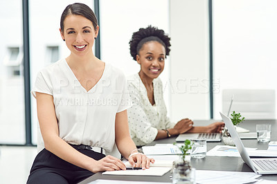Buy stock photo Portrait of two businesswoman sitting together in an office