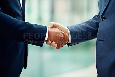 Buy stock photo Cropped shot of two unidentifiable businessmen shaking hands in the office