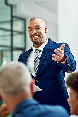 Buy stock photo Cropped shot of a businessman  introducing his colleague during a meeting in the boardroom