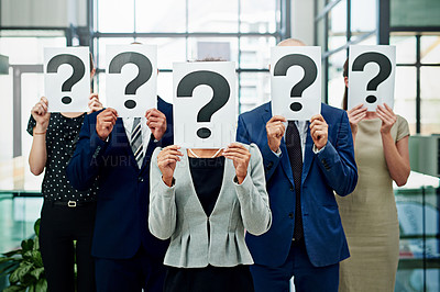 Buy stock photo Cropped shot of a group of unidentifiable businesspeople holding placards with question marks on them in front of their faces