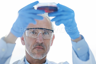 Buy stock photo Cropped shot of a male scientist conducting an experiment in a lab