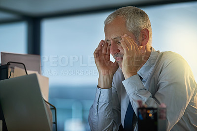 Buy stock photo Cropped shot of a mature businessman looking stressed out at his desk