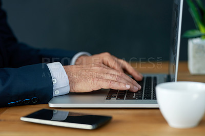 Buy stock photo Closeup shot of a businessman working on a laptop in an office