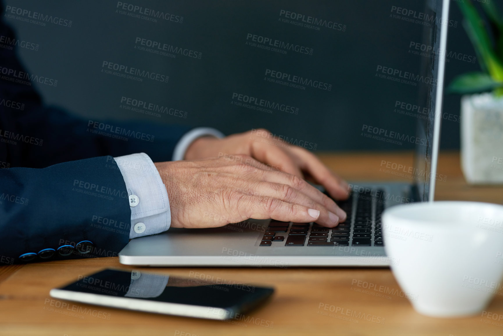 Buy stock photo Closeup shot of a businessman working on a laptop in an office