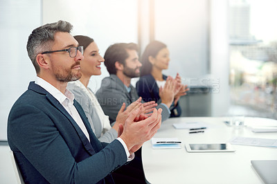 Buy stock photo Cropped shot of a group of businesspeople clapping their hands together in a modern office