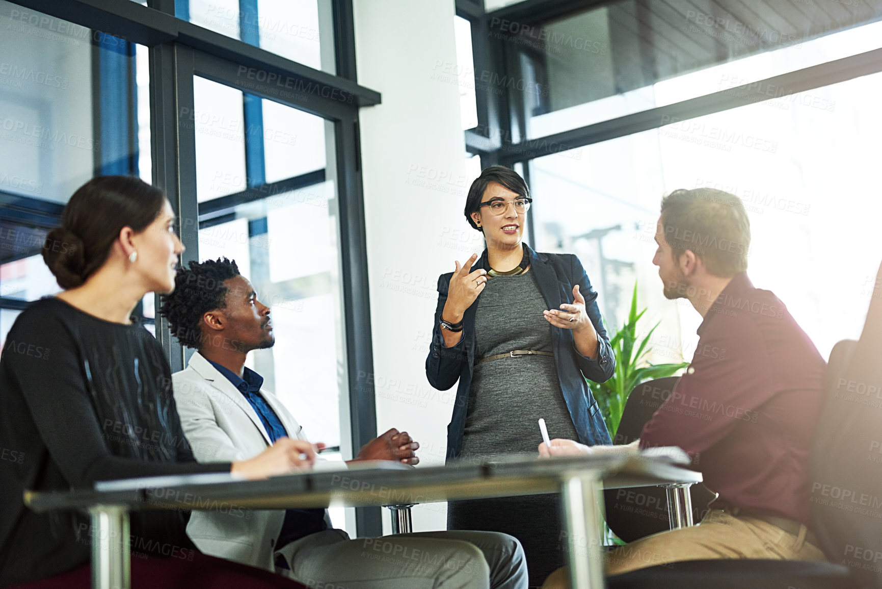 Buy stock photo Shot of a businesswoman delivering a presentation to her coworkers