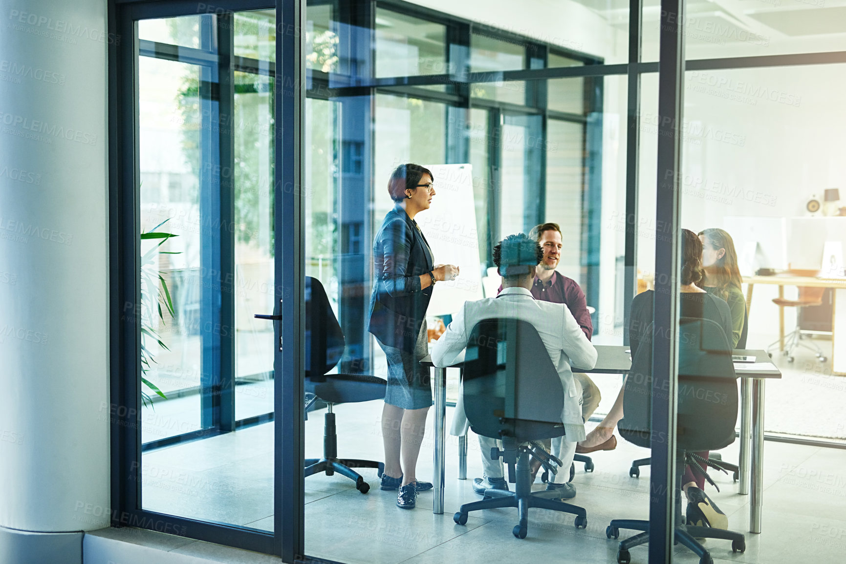 Buy stock photo Shot of a businesswoman delivering a presentation to her coworkers