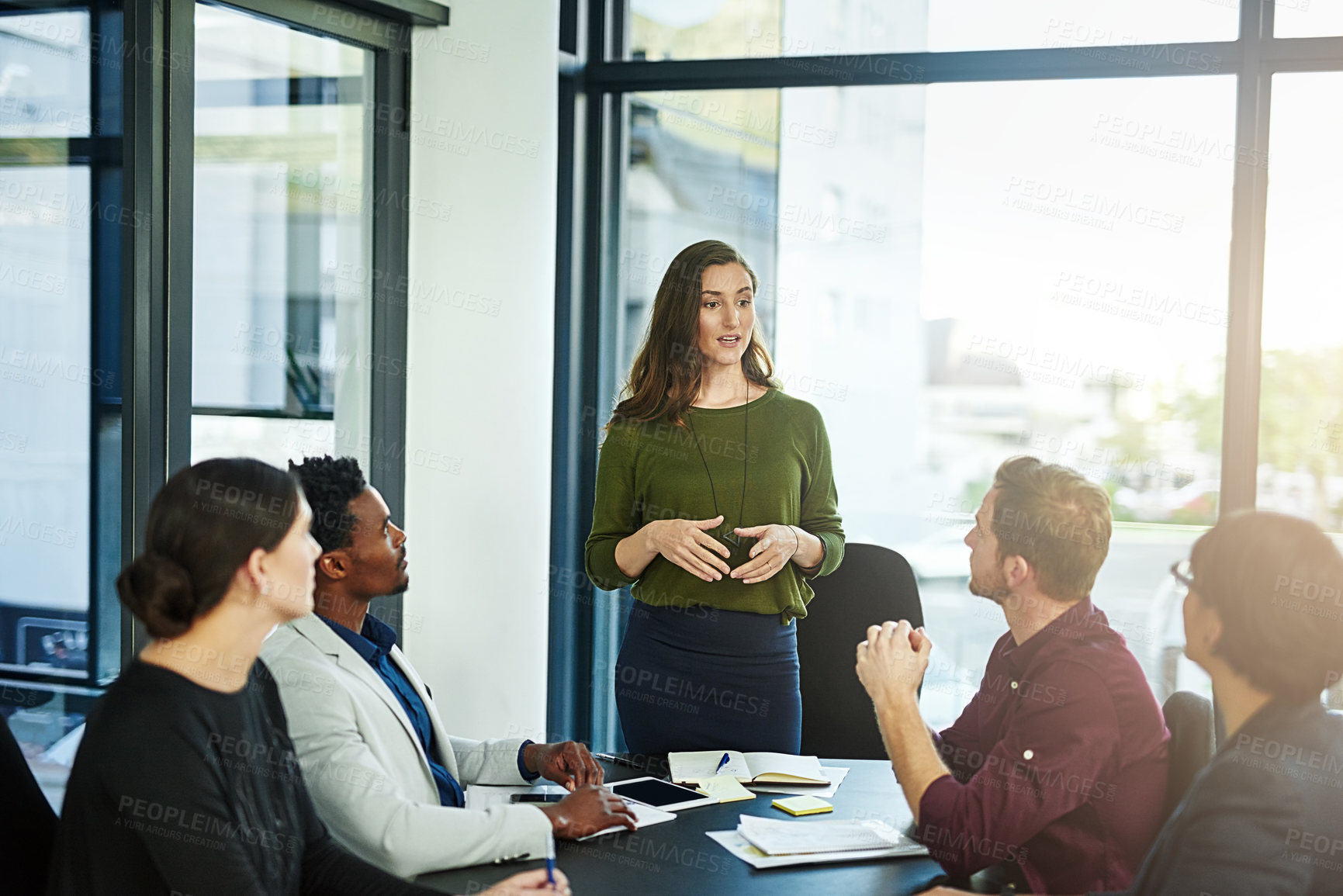 Buy stock photo Shot of a businesswoman delivering a presentation to her coworkers