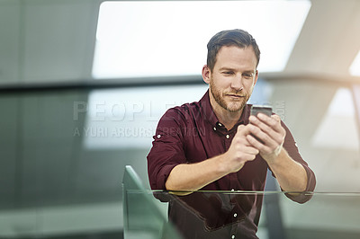 Buy stock photo Businessman, typing and reading with phone at office for networking, communication or sending message. Young man or employee on mobile smartphone for online texting, app or conversation at workplace