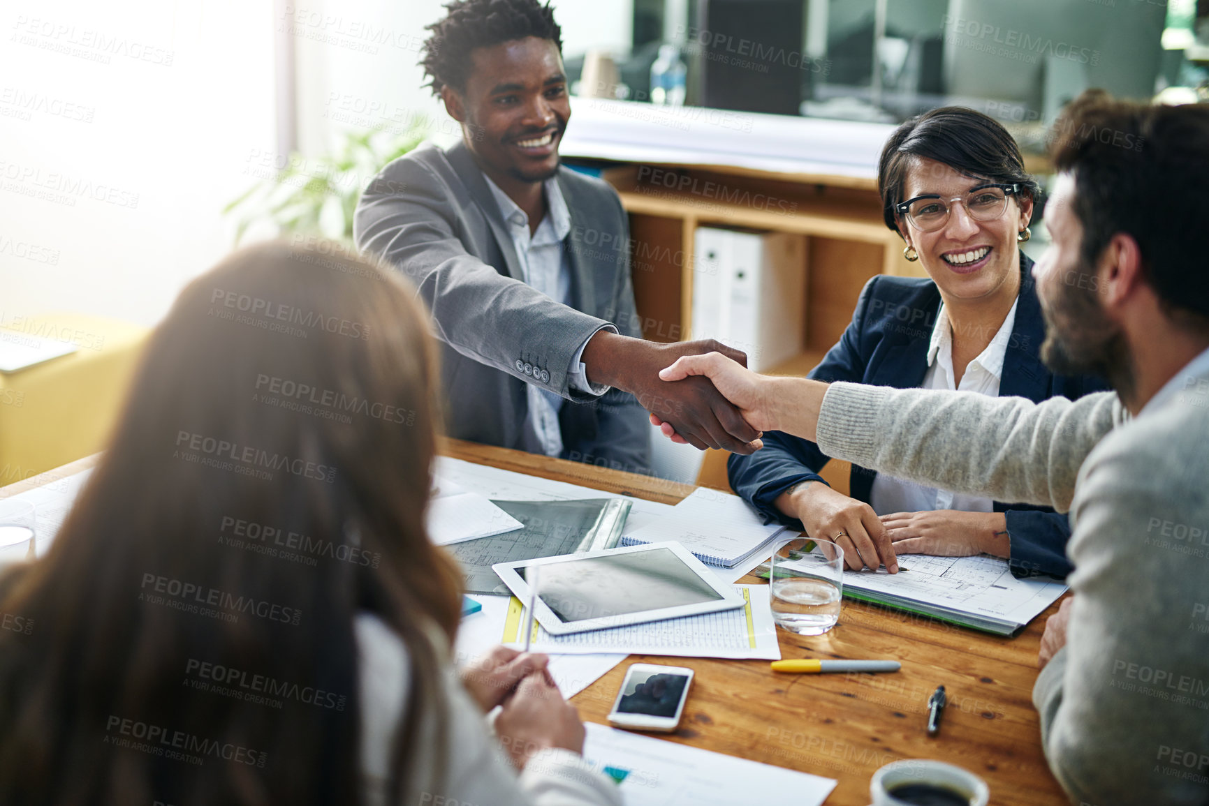 Buy stock photo Cropped shot of two businessmen shaking hands during a meeting