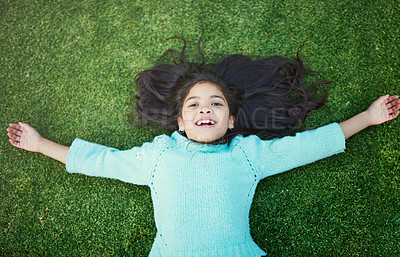 Buy stock photo Child, grass and portrait with smile for resting in park on weekend with top view in nature or garden. Development, preteen and green in summer with backyard or vacation in childhood with freedom.