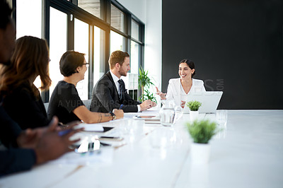 Buy stock photo Cropped shot of a group of business colleagues meeting in the boardroom