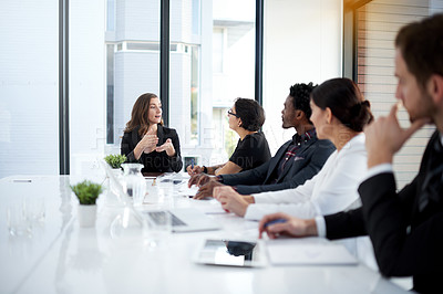 Buy stock photo Cropped shot of a group of business colleagues meeting in the boardroom