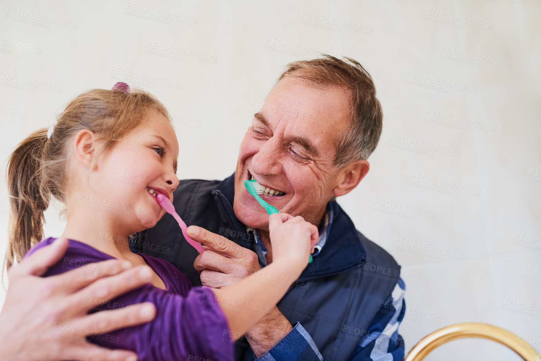 Buy stock photo Shot of a father and his young daughter brushing their teeth together