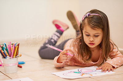 Buy stock photo Shot of a little girl colouring in a picture at home