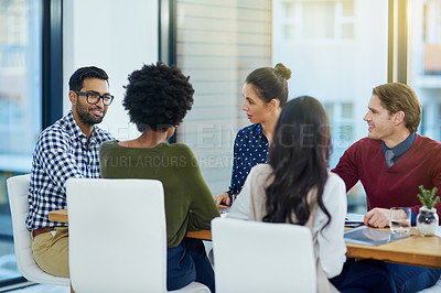 Buy stock photo Shot of a group of business people having a meeting in the boardroom