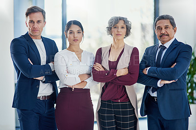 Buy stock photo Cropped portrait of a diverse group of businesspeople standing with their arms crossed in the office