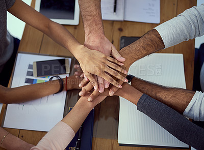 Buy stock photo Cropped shot of a group of colleagues joining their hands together in agreement