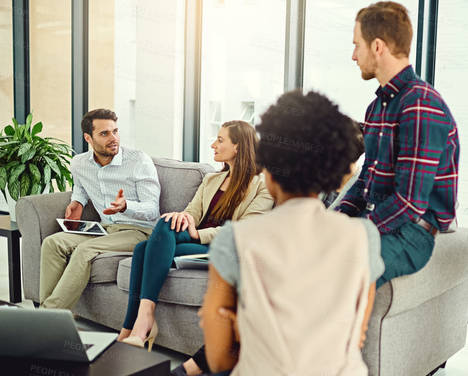 Buy stock photo Brainstorming, discussion and business people with tablet on sofa for communication, teamwork and conversation in office. Planning, ideas and employees with computer or technology for startup project