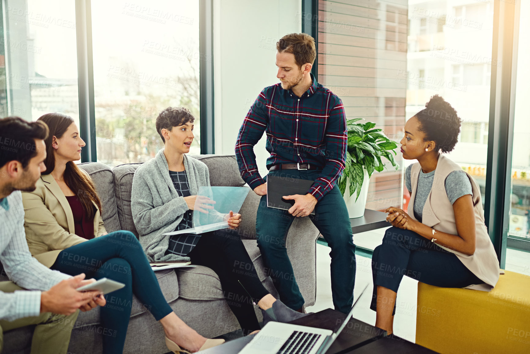 Buy stock photo Brainstorming, discussion and business people with file on sofa for communication, teamwork and conversation in office. Planning, ideas and employees with computer or technology for startup project