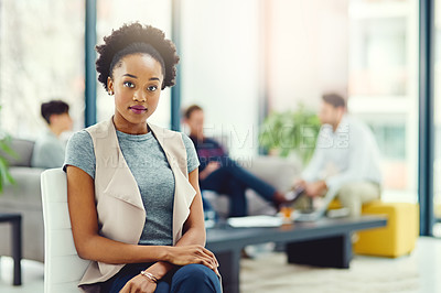 Buy stock photo Portrait of a confident young creative sitting in an office with colleagues in the background