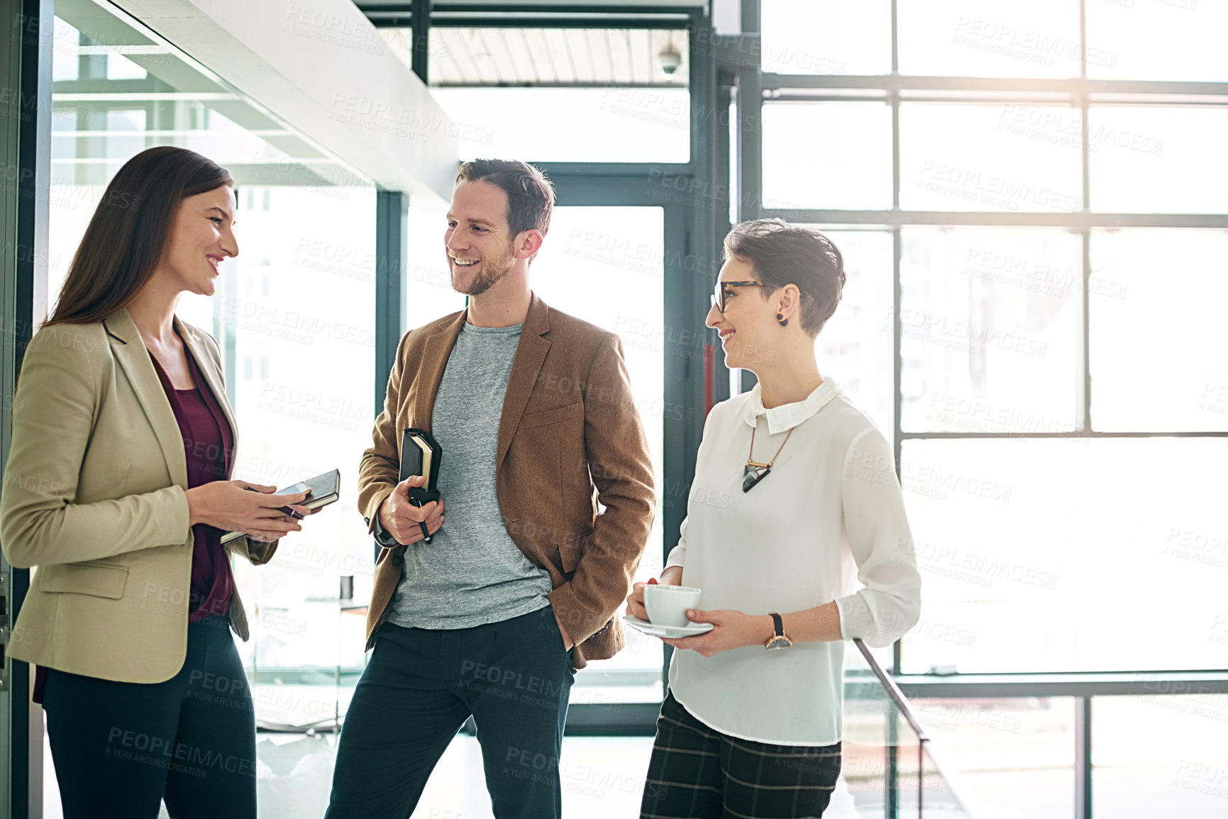 Buy stock photo Business people, break and talking with smile in office for conversation, discussion and laugh together. Journalists, man and women with communication, funny joke or sharing nostalgic memory