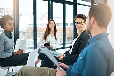 Buy stock photo Cropped shot of a group of colleagues having a meeting together in an office