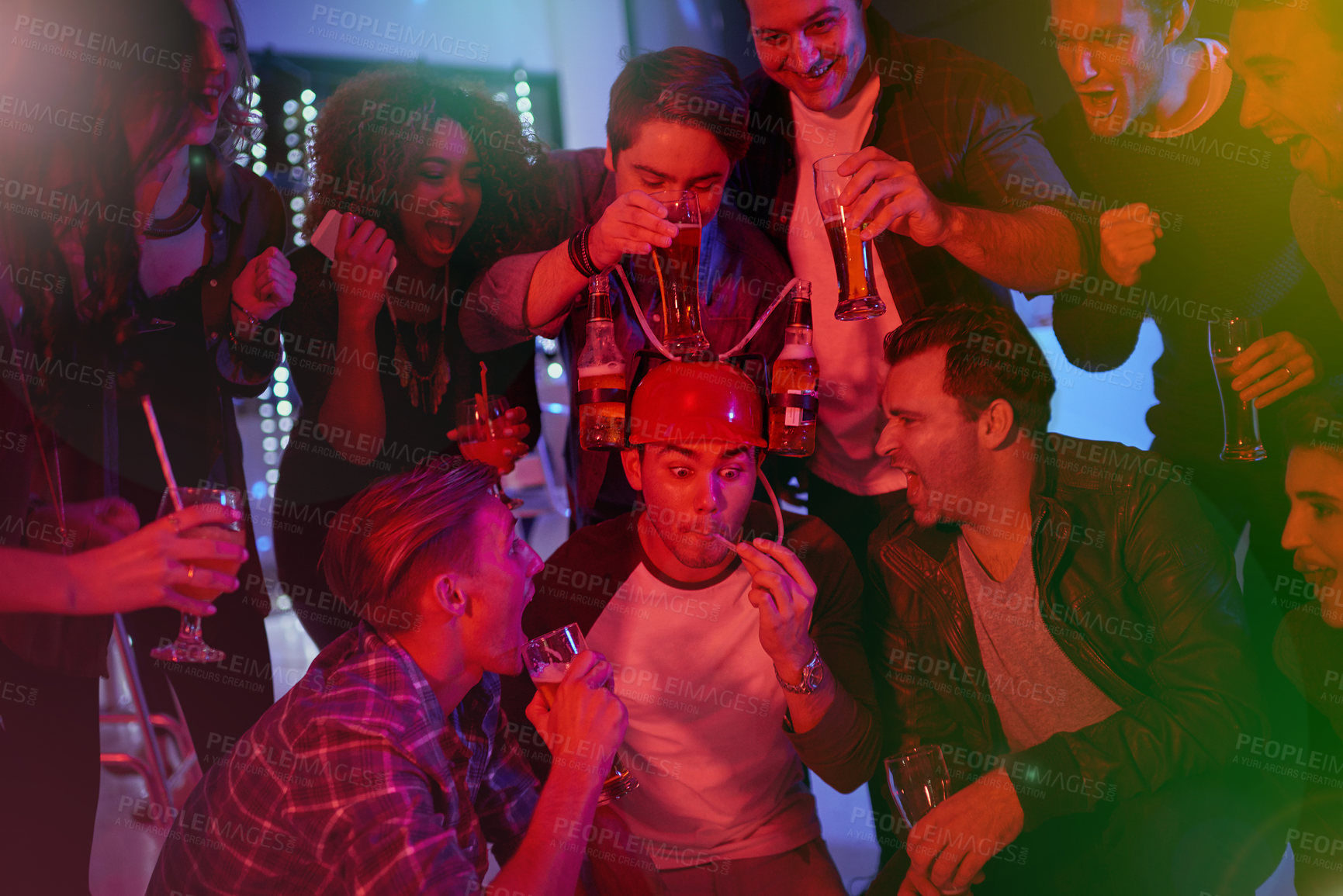Buy stock photo Cropped shot of a group of friends drinking and having fun at a party