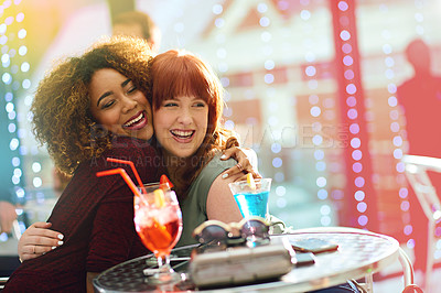 Buy stock photo Shot of two young friends having drinks together at a party