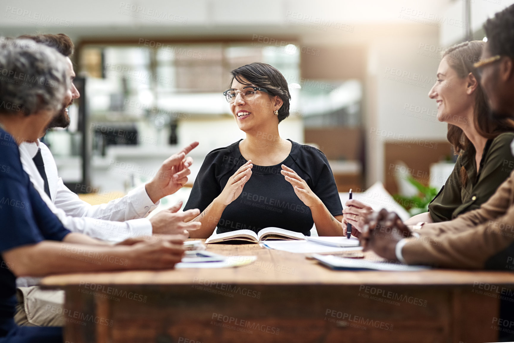 Buy stock photo Cropped shot of a group of businesspeople having a meeting in an office