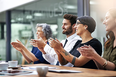 Buy stock photo Cropped shot of a group of businesspeople applauding together in an office