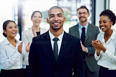 Buy stock photo Portrait of a succesful businessman being applauded by his colleagues in the office