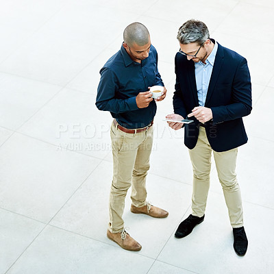 Buy stock photo High angle shot of two businessmen talking in the office
