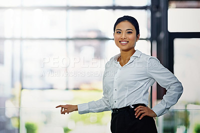 Buy stock photo Portrait of a young businesswoman standing with her hand on her hip in the office