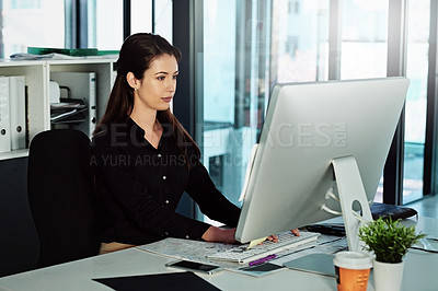 Buy stock photo Cropped shot of a young businesswoman sitting at her desk in the office