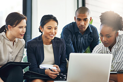 Buy stock photo Shot of a group of businesspeople talking together over a laptop during a meeting