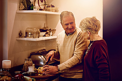 Buy stock photo Cropped shot of an elderly woman watching her husband prepare a meal in their kitchen